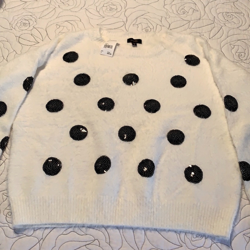 White sweater with black dots.